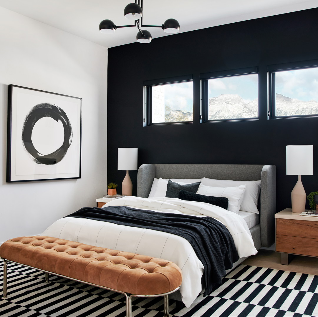 a black and white bedroom with a large bed