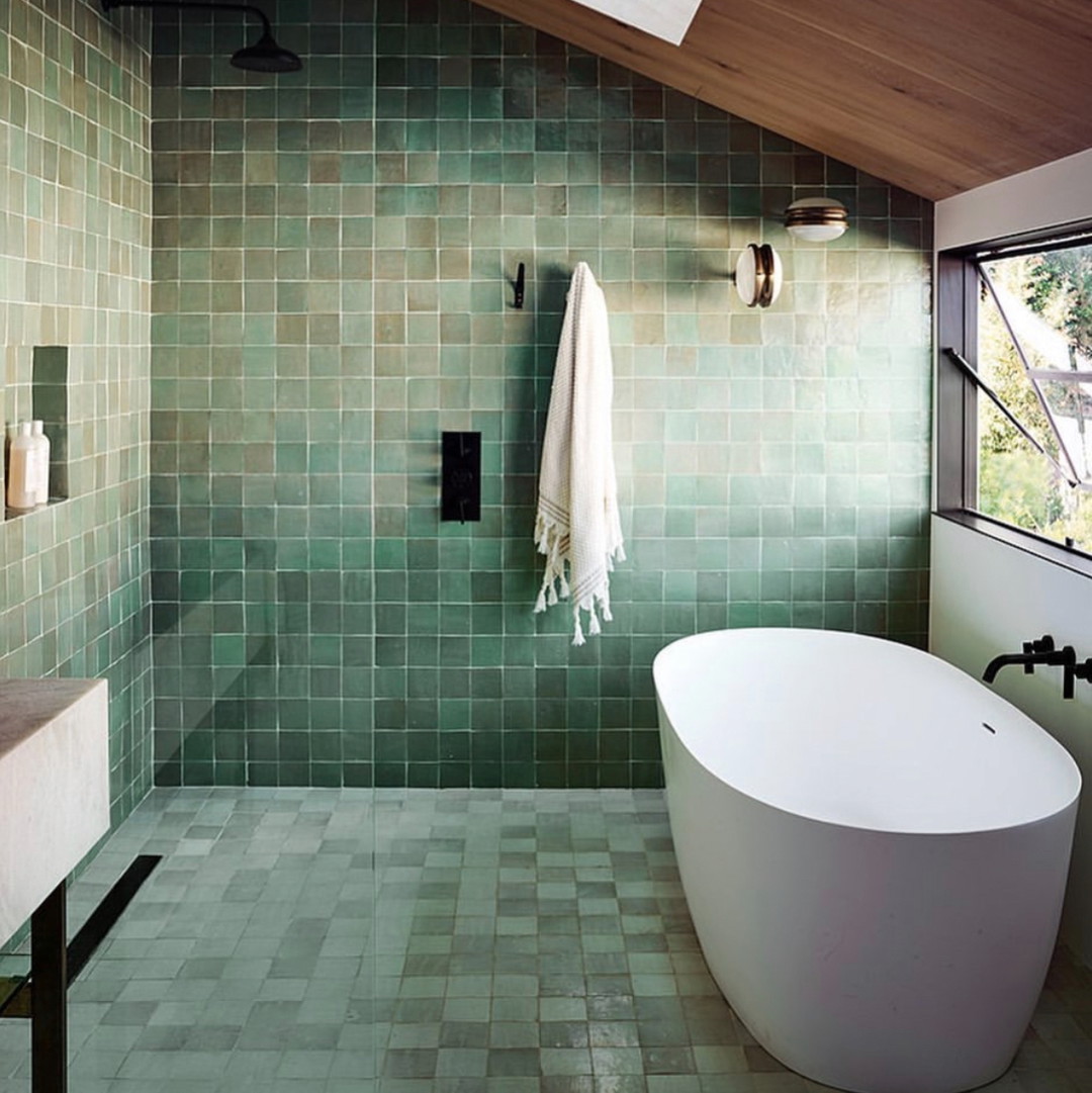 a bathroom with a bathtub and a window