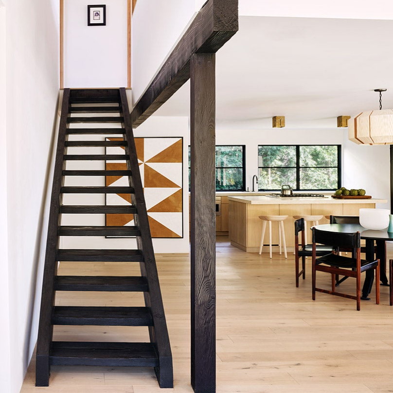 a staircase leading up to a dining room table