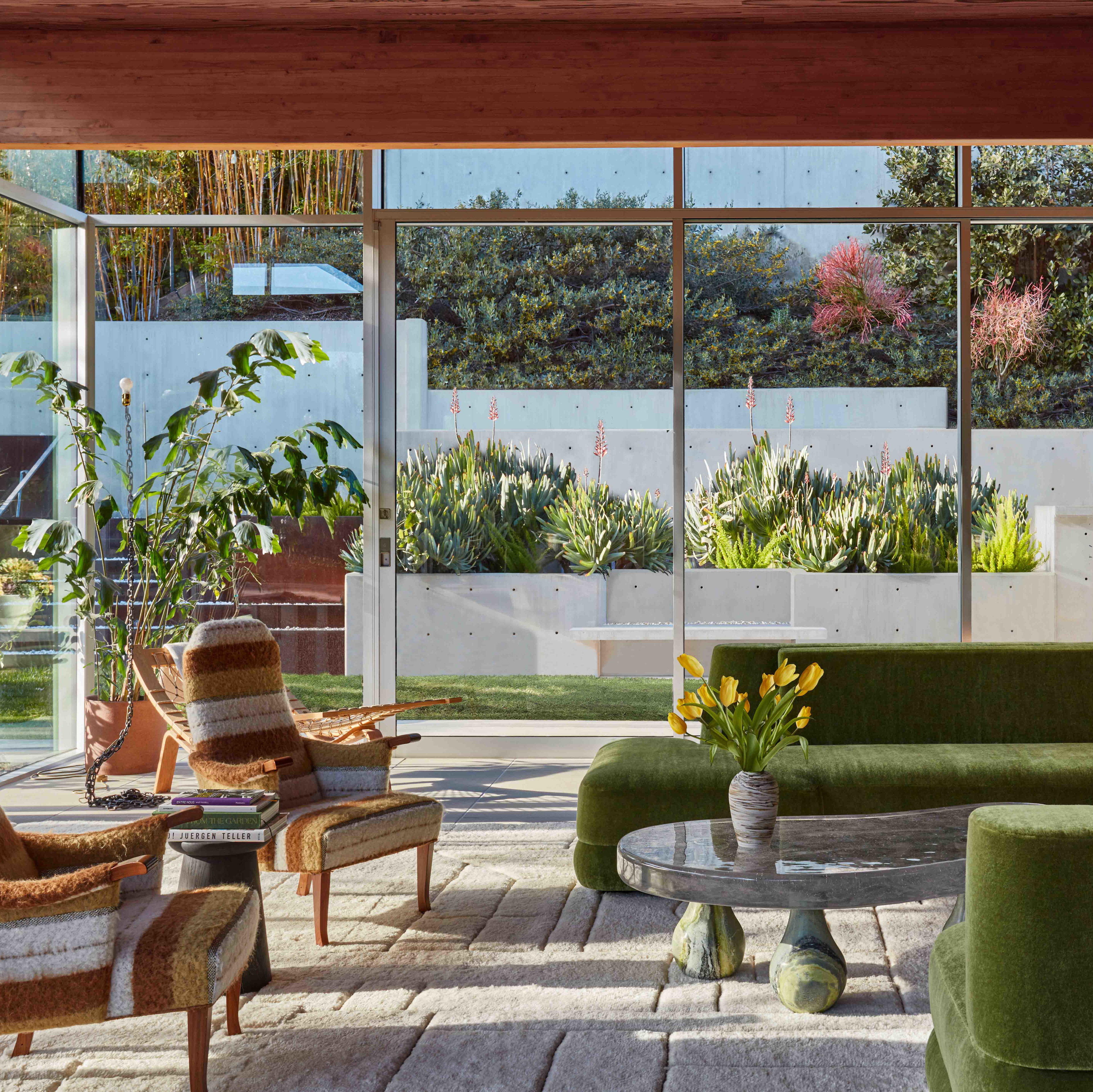 a living room filled with lots of green furniture