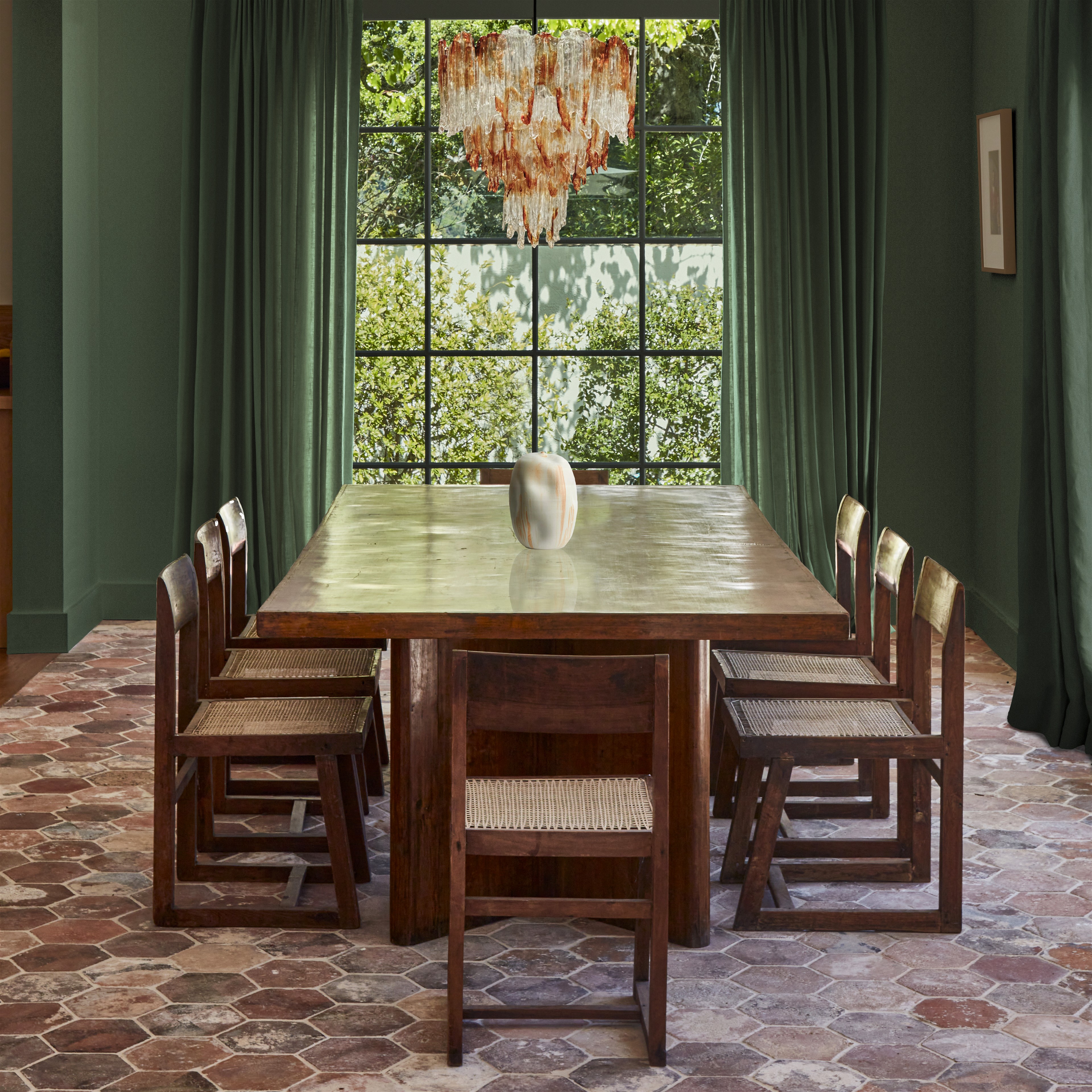 a dining room with a large wooden table and chairs