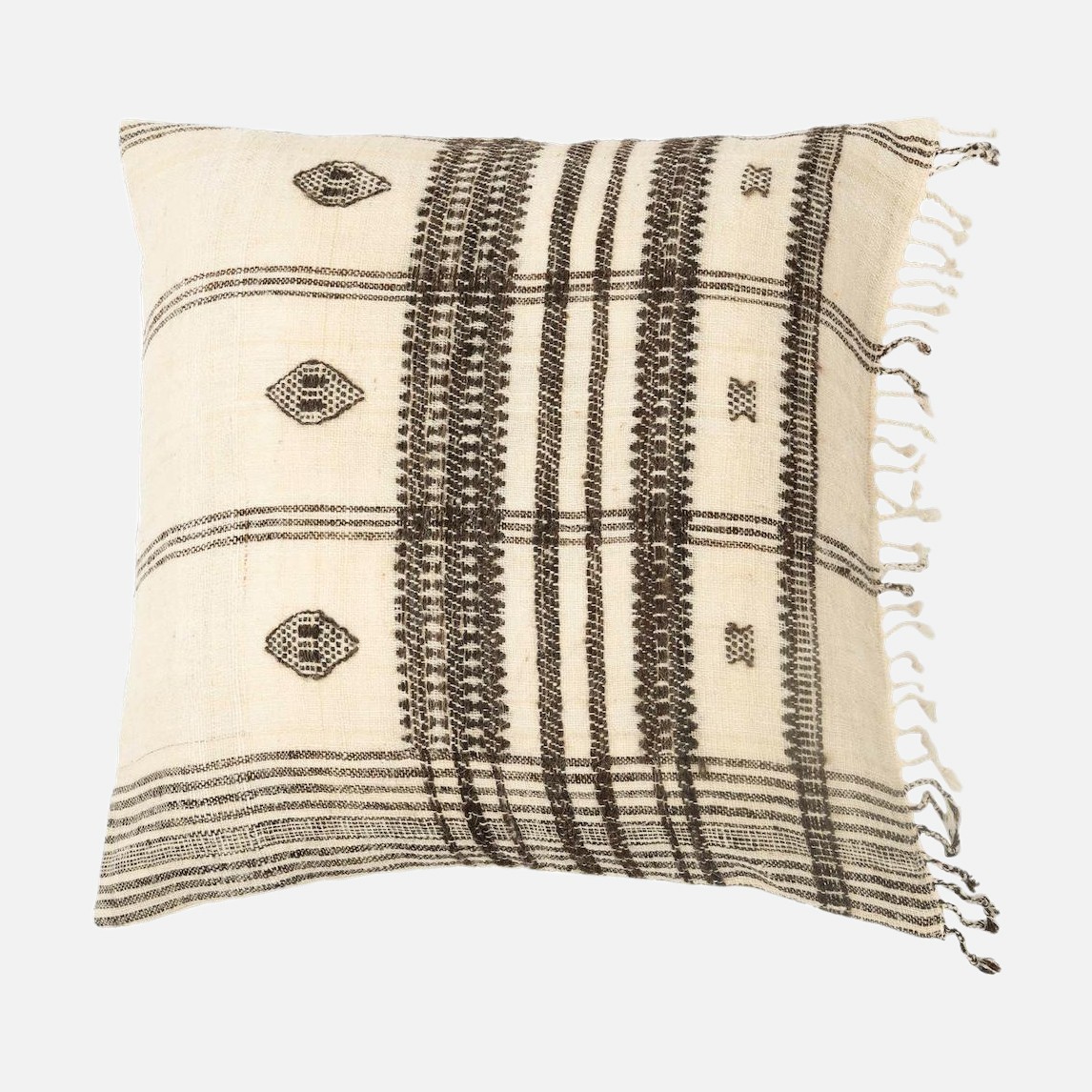 a black and white pillow with fringes on it