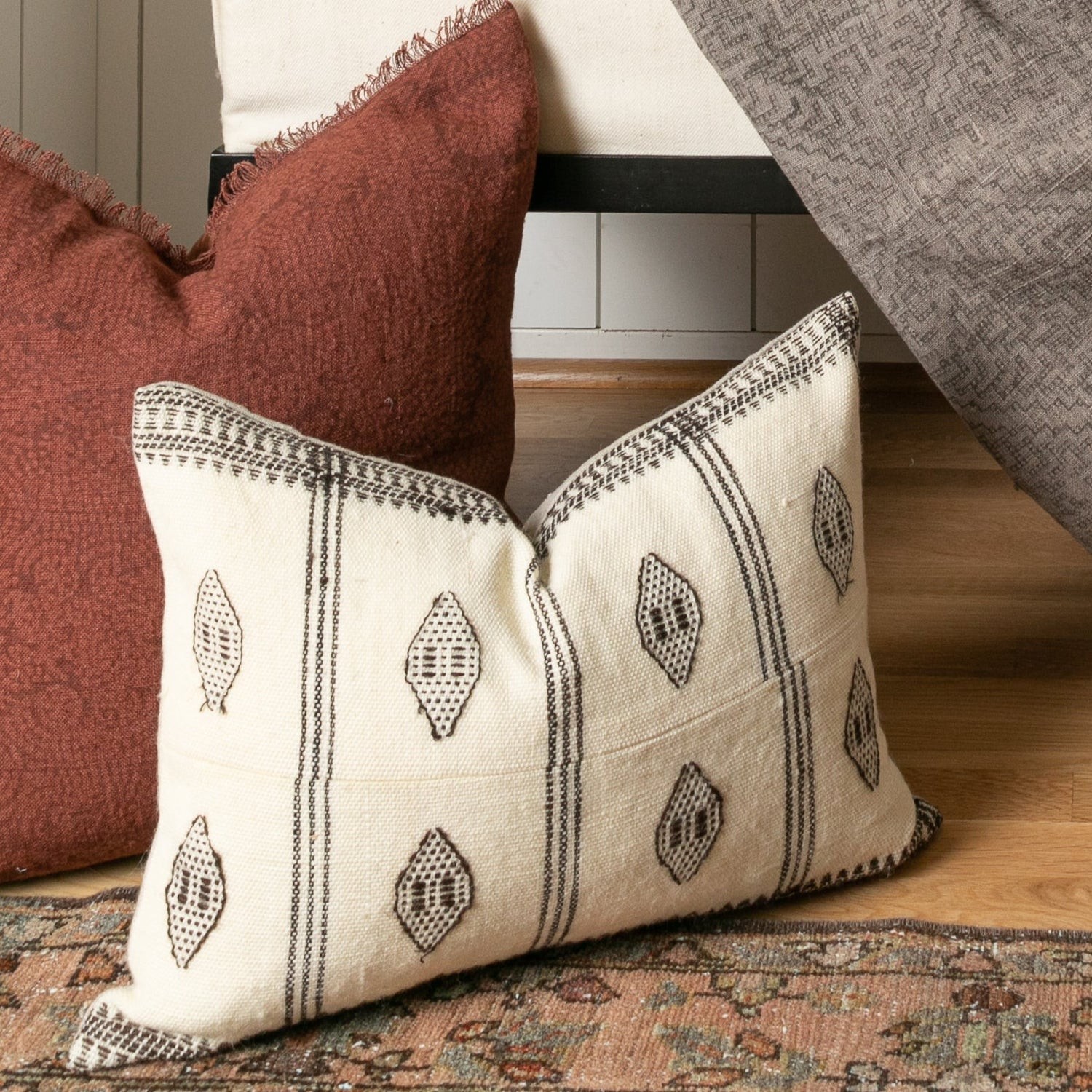 two pillows sitting on top of a wooden floor