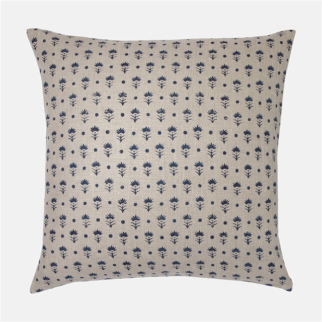 a blue and white pillow on a white background
