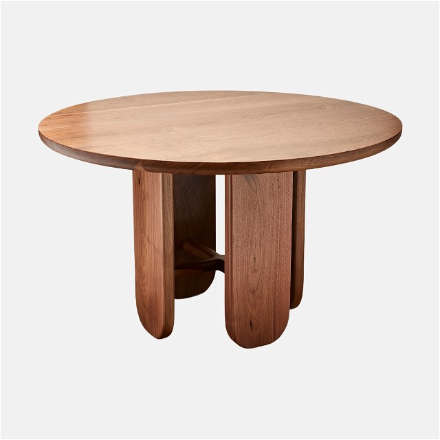 a round wooden table with a wooden base