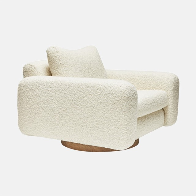 a white chair with two pillows on top of it