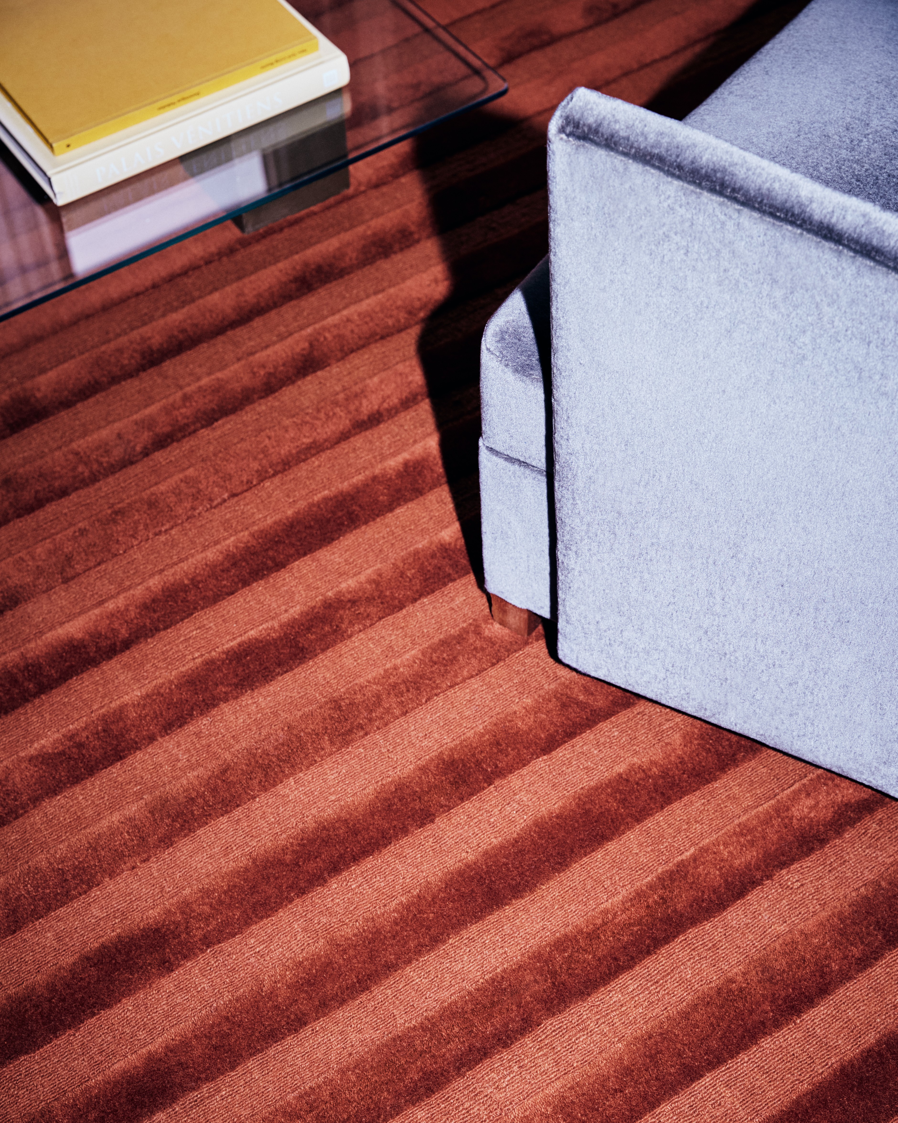 a chair sitting on top of a wooden floor next to a book