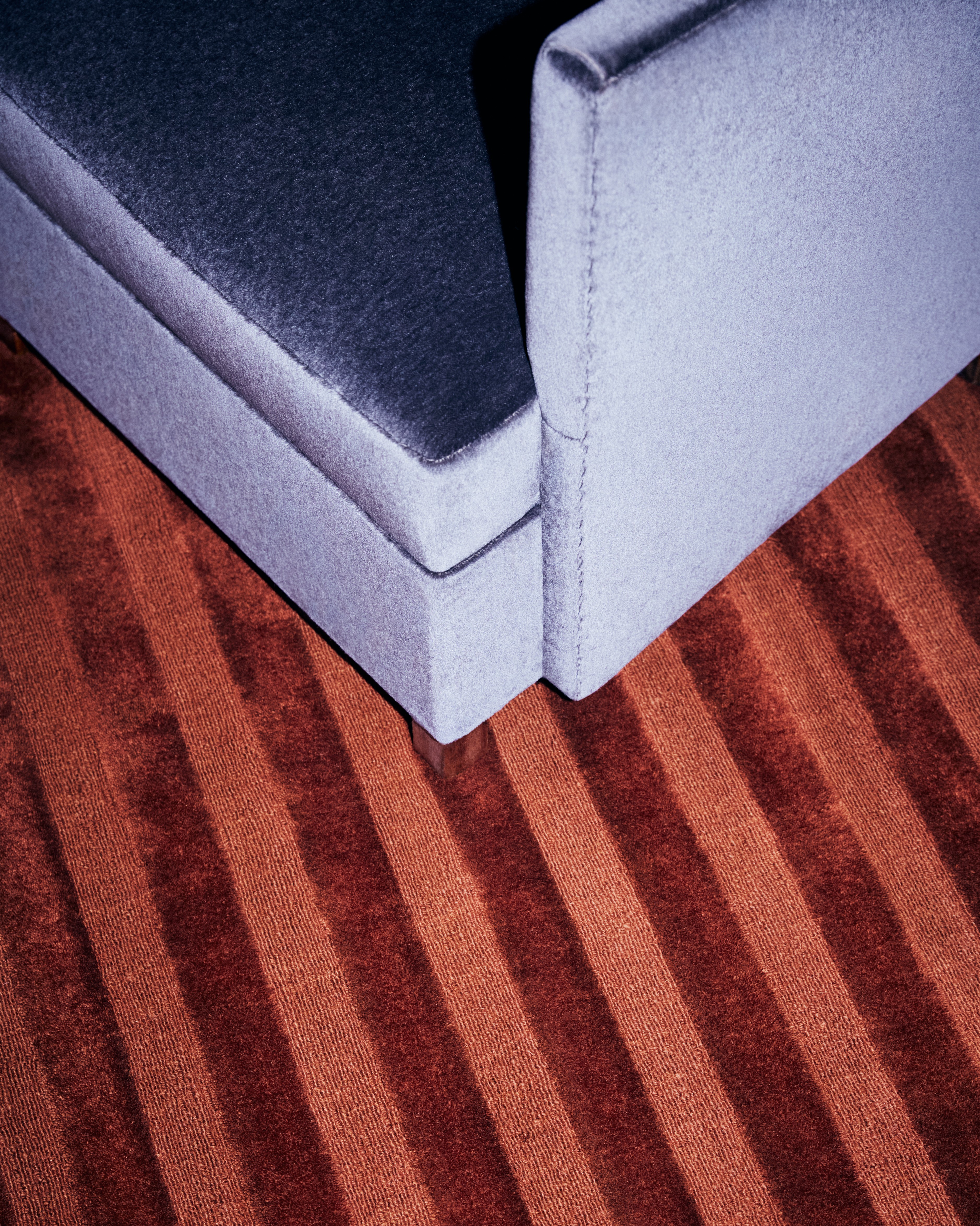 a close up of a couch on a wooden floor