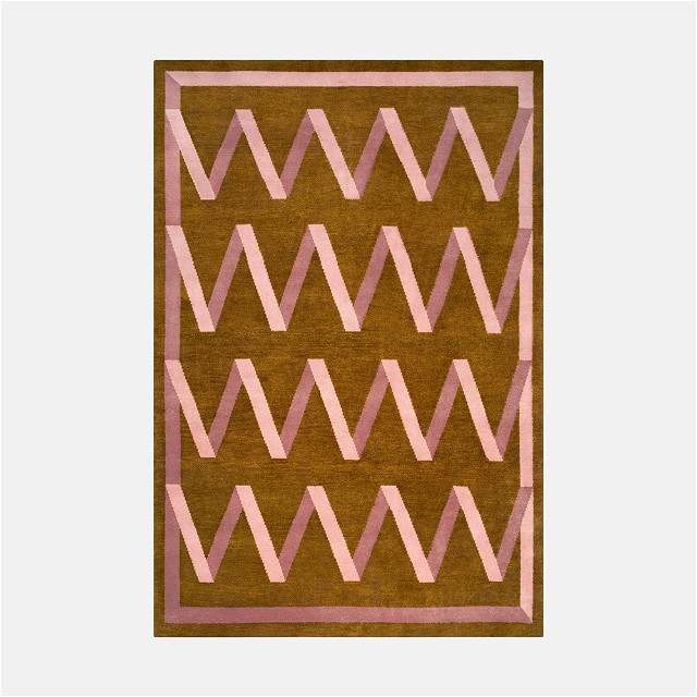 a brown and pink rug with a design on it