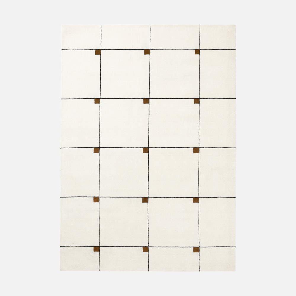 a white rug with brown squares on it