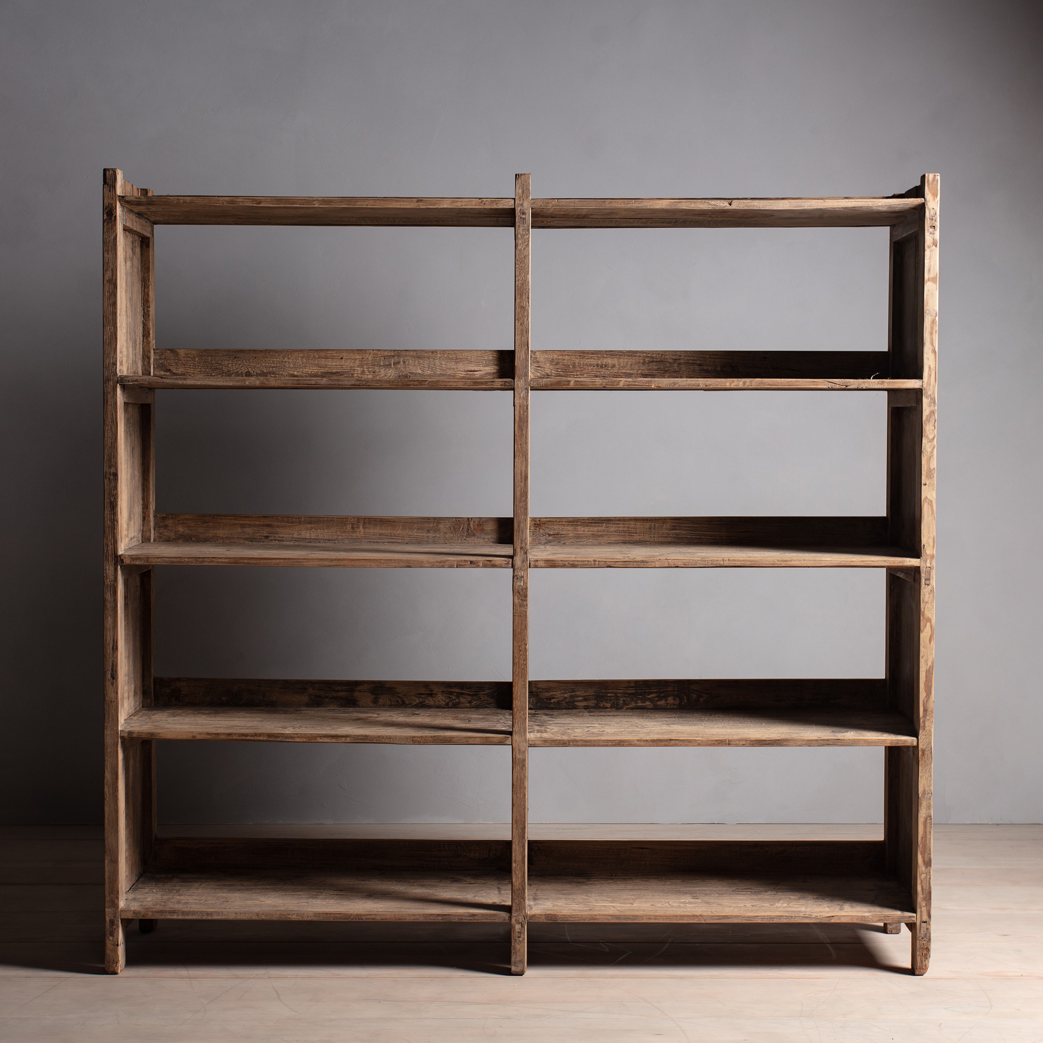 a wooden shelf with a few shelves on top of it