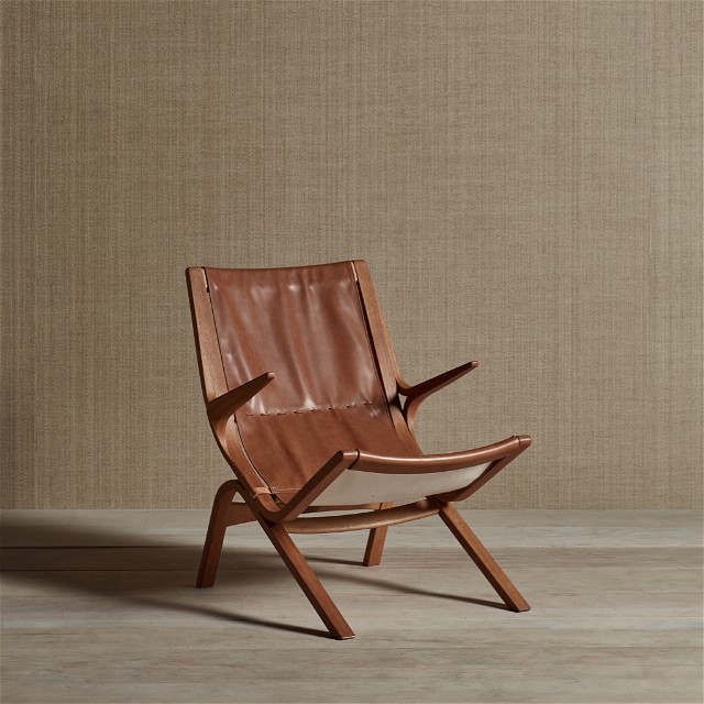 a wooden chair with a leather seat on a wooden floor