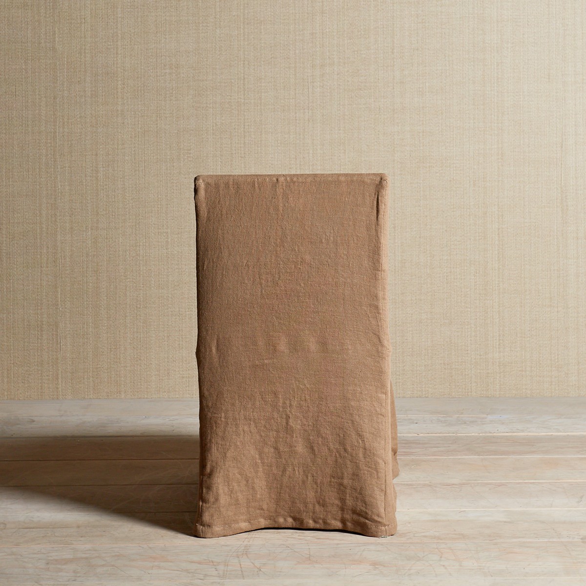 a brown bag sitting on top of a wooden floor