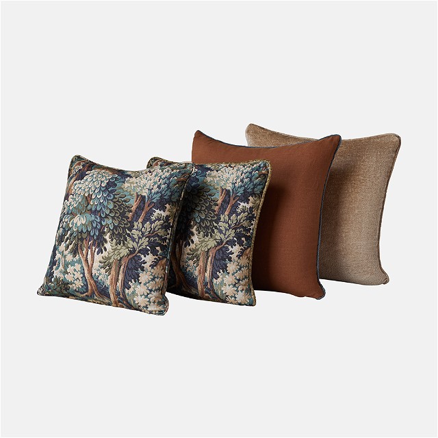 a set of four pillows with a tree design