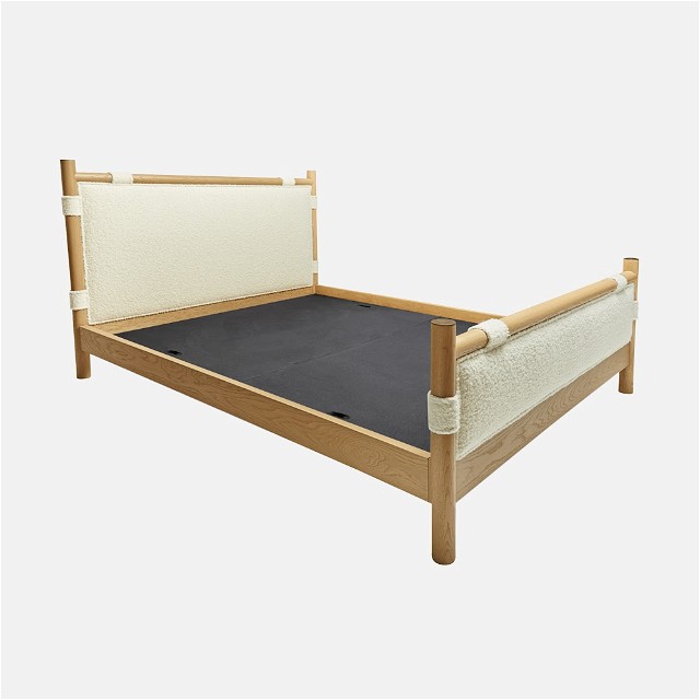 a bed with a wooden frame and mattress