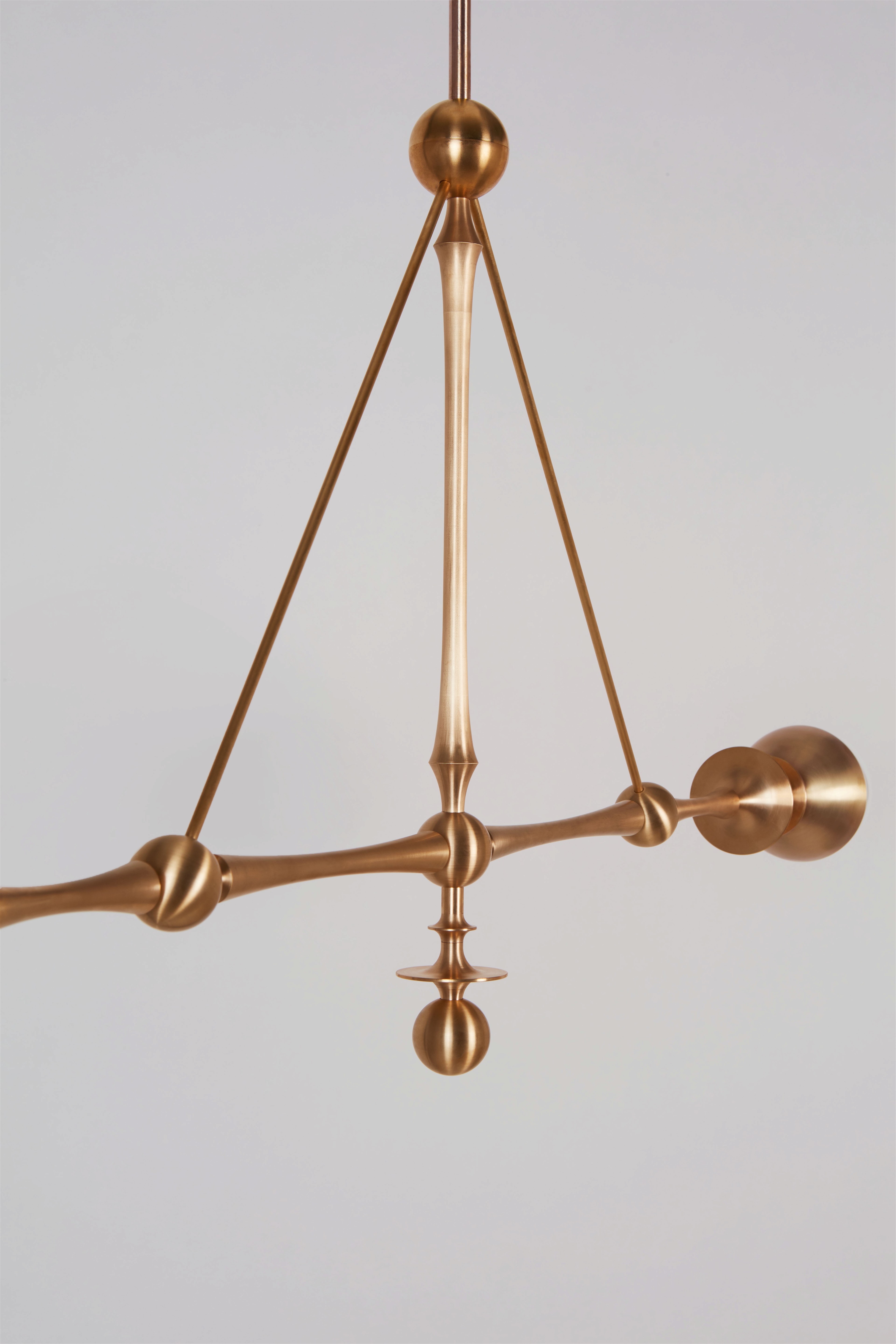 a brass chandelier hanging from a ceiling