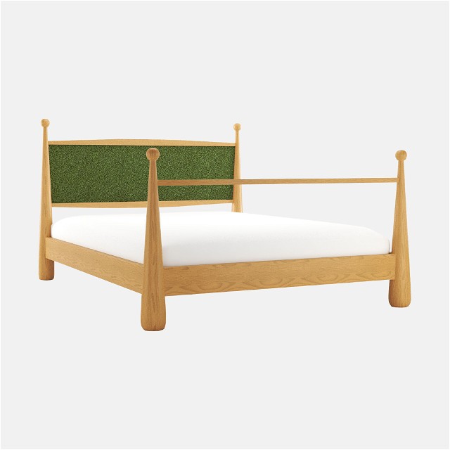 a bed with a green headboard and foot board