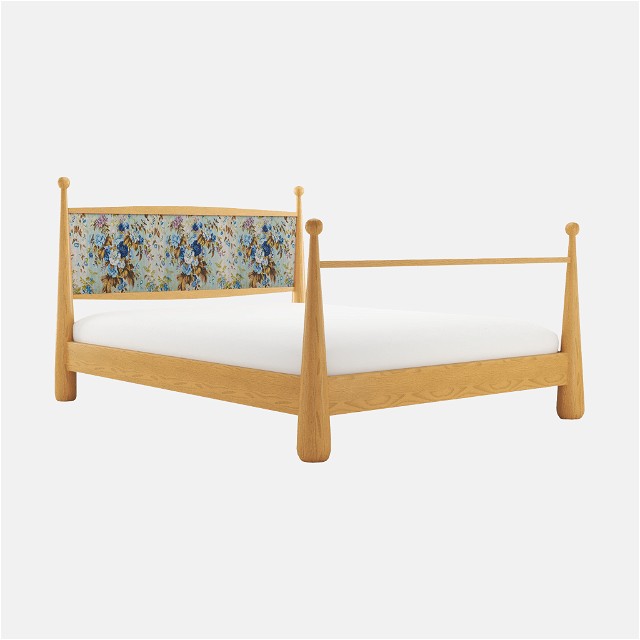a bed with a wooden frame and white sheets