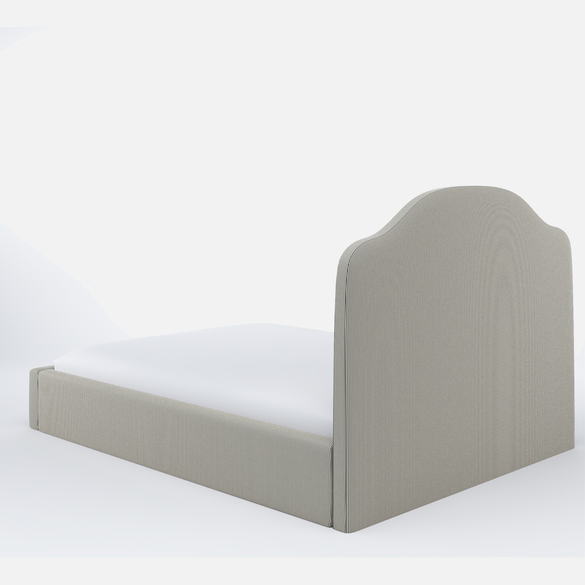 a bed with a white sheet and a gray headboard