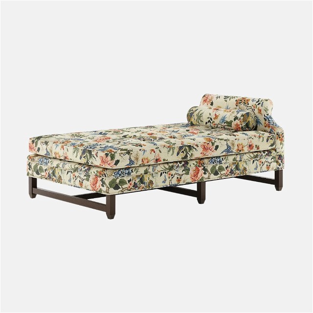 a floral chaise lounge chair with a wooden frame