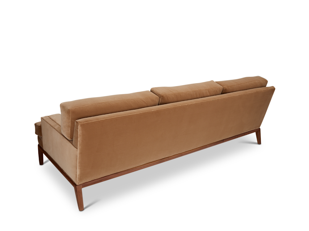 a couch with a wooden frame and a brown upholstered back