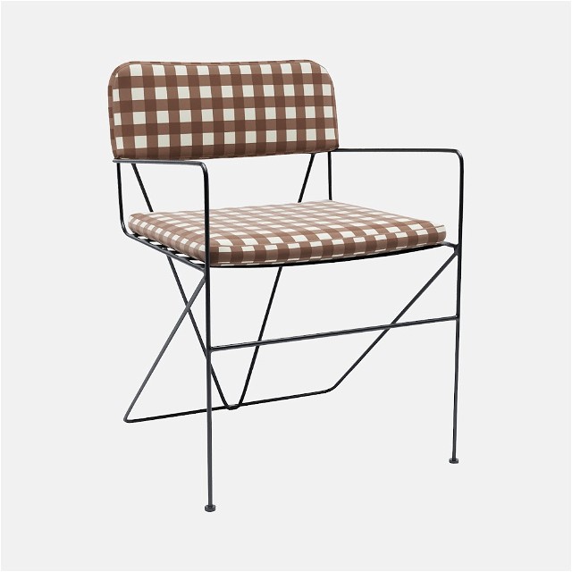 a brown and white checkered chair with a black frame