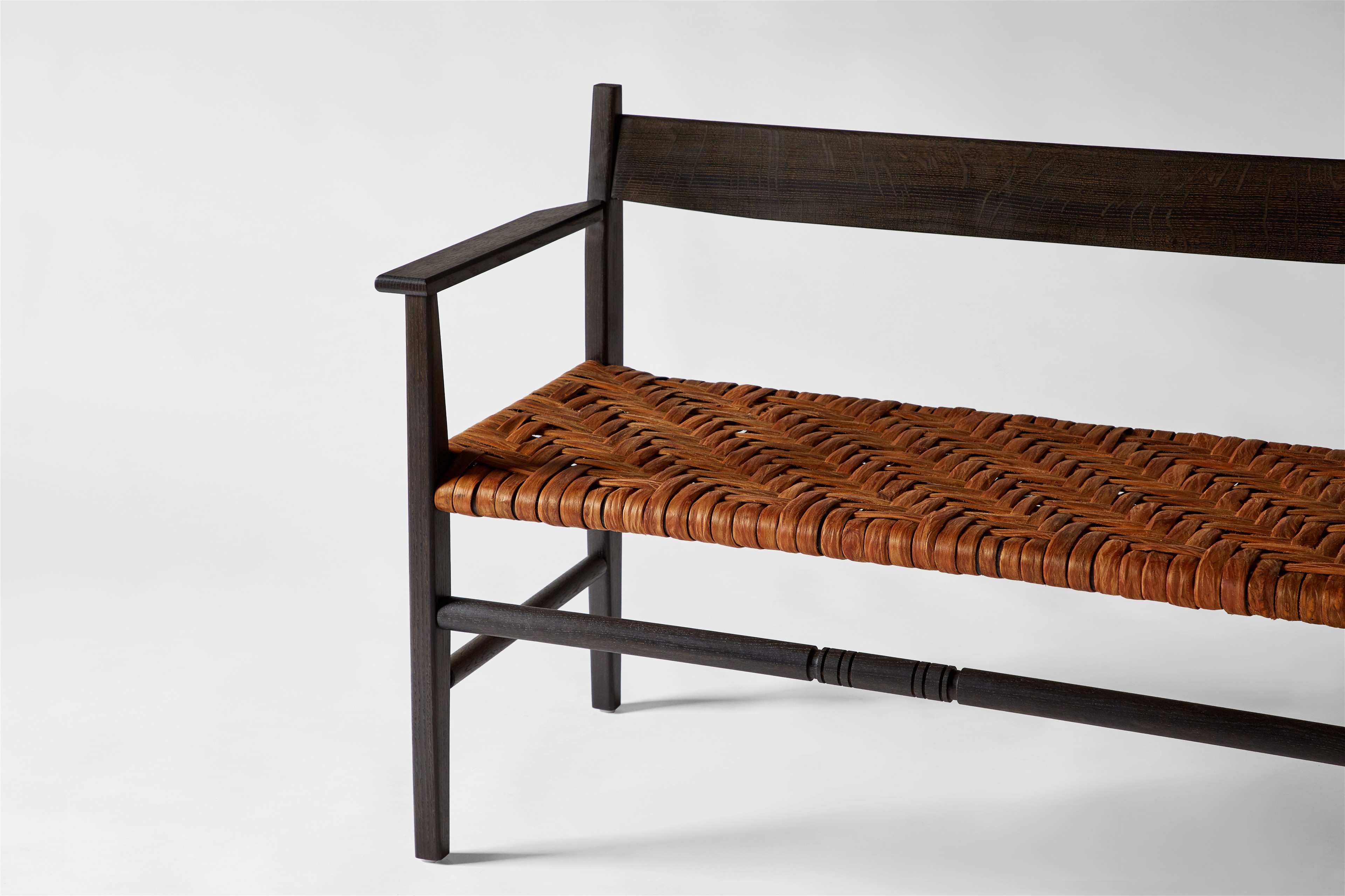 a wooden bench with a woven seat
