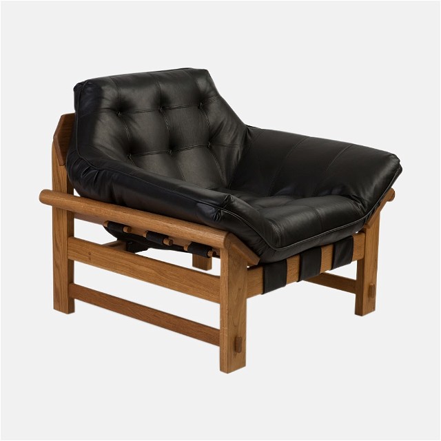 a black leather chair with a wooden frame