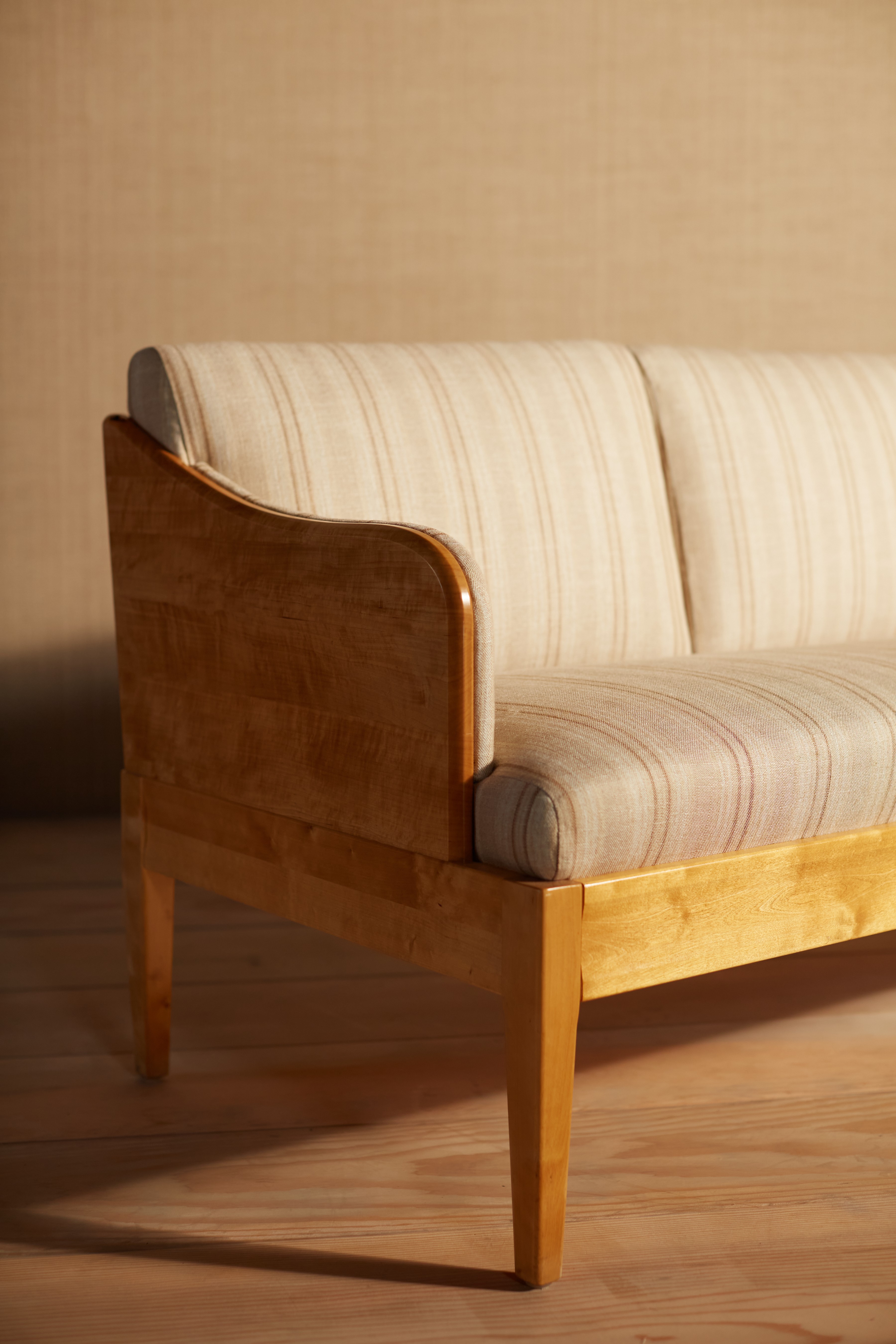 a wooden couch sitting on top of a hard wood floor