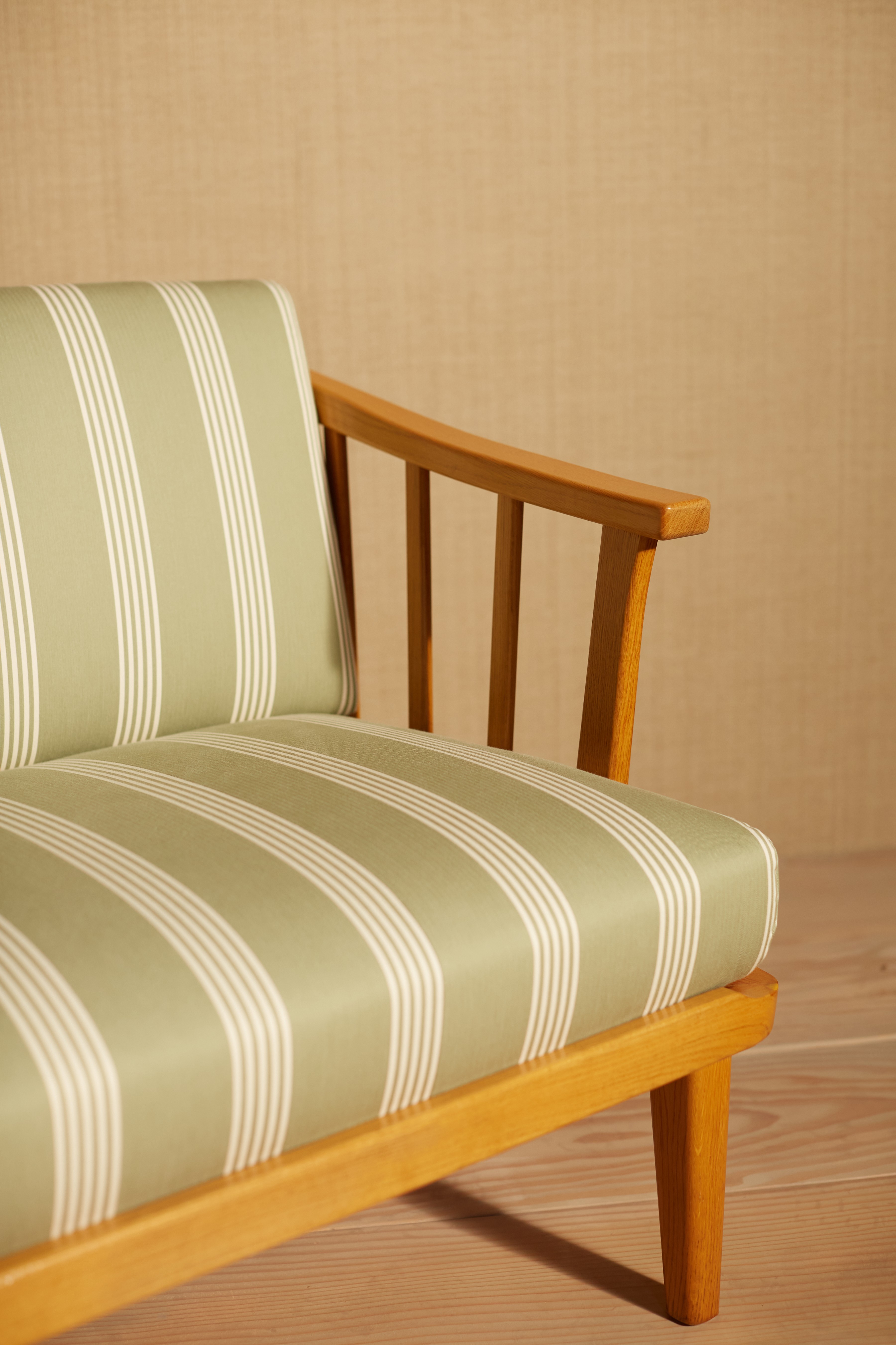 a wooden chair with a striped seat cushion