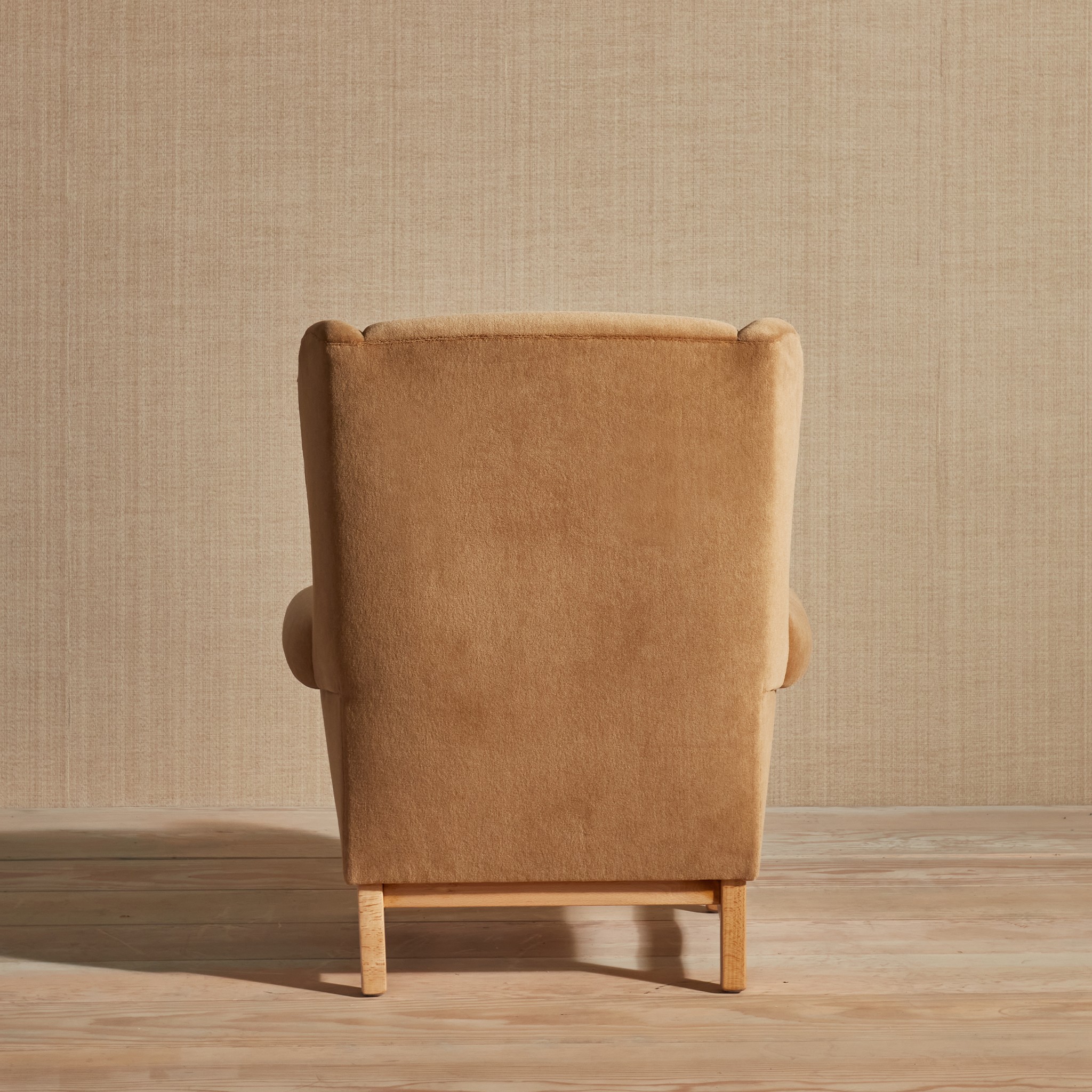 a brown chair sitting on top of a wooden floor