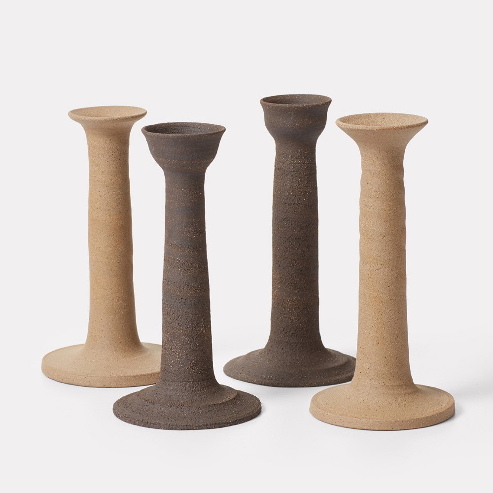 a group of three tall vases sitting next to each other