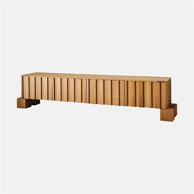 a wooden bench sitting on top of a white wall