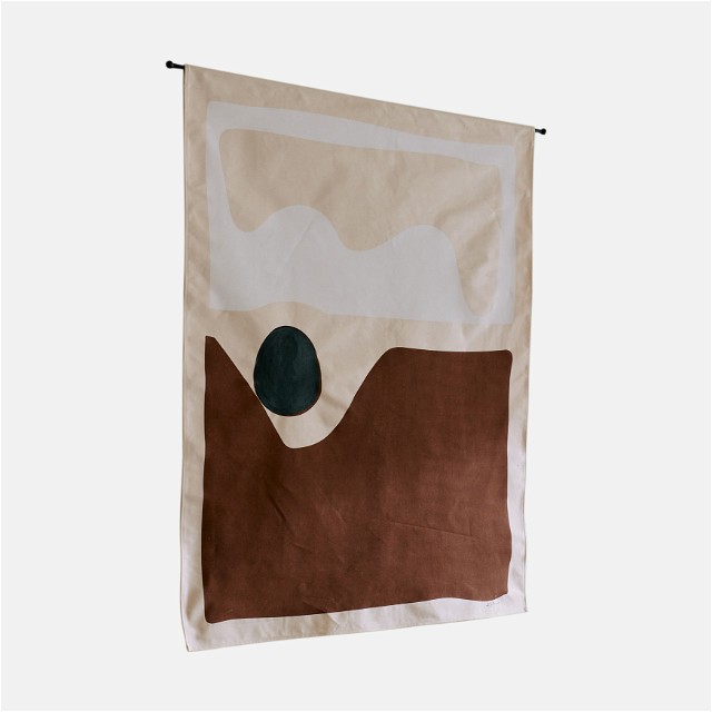 a brown and white flag hanging on a wall