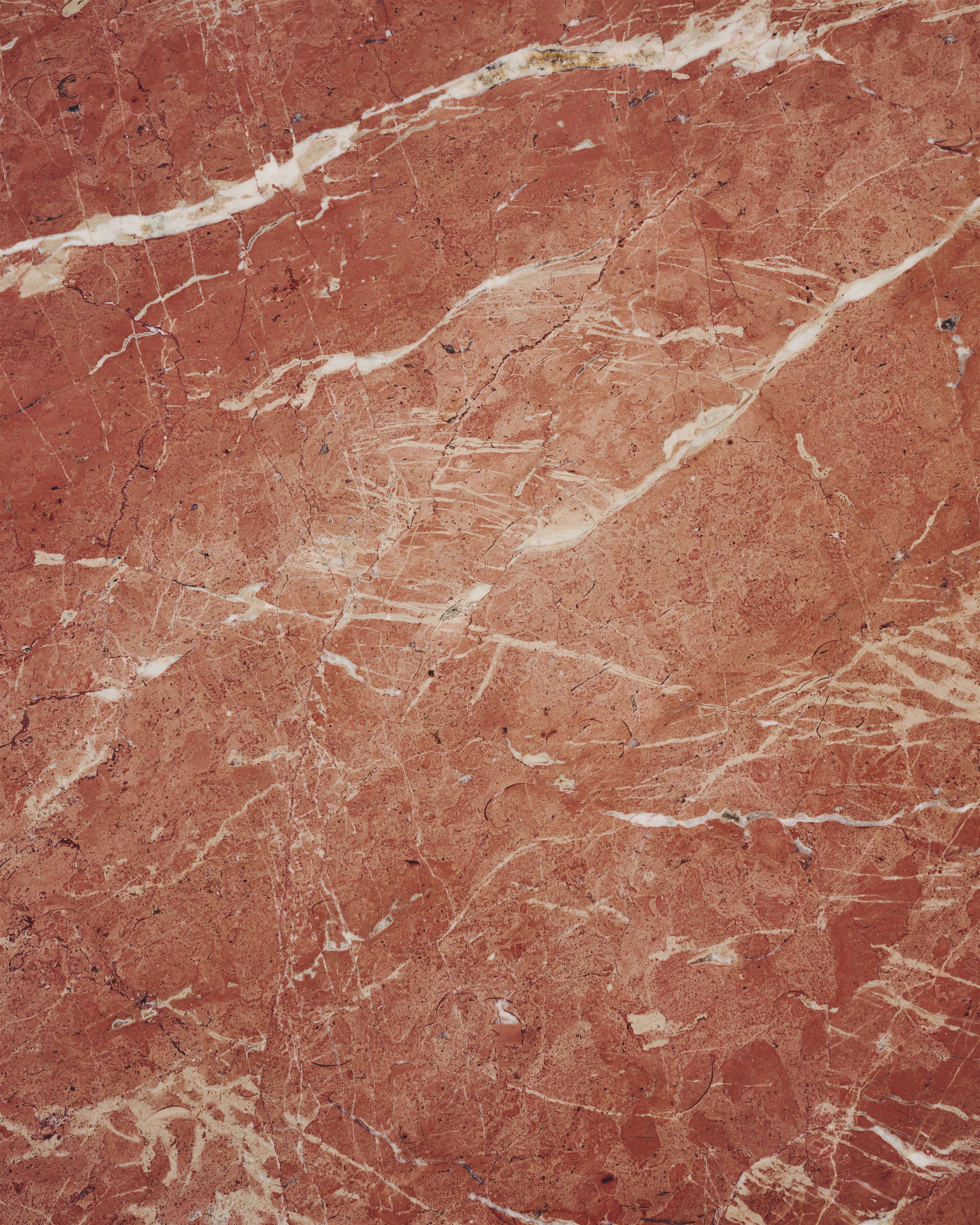 a close up of a red marble surface