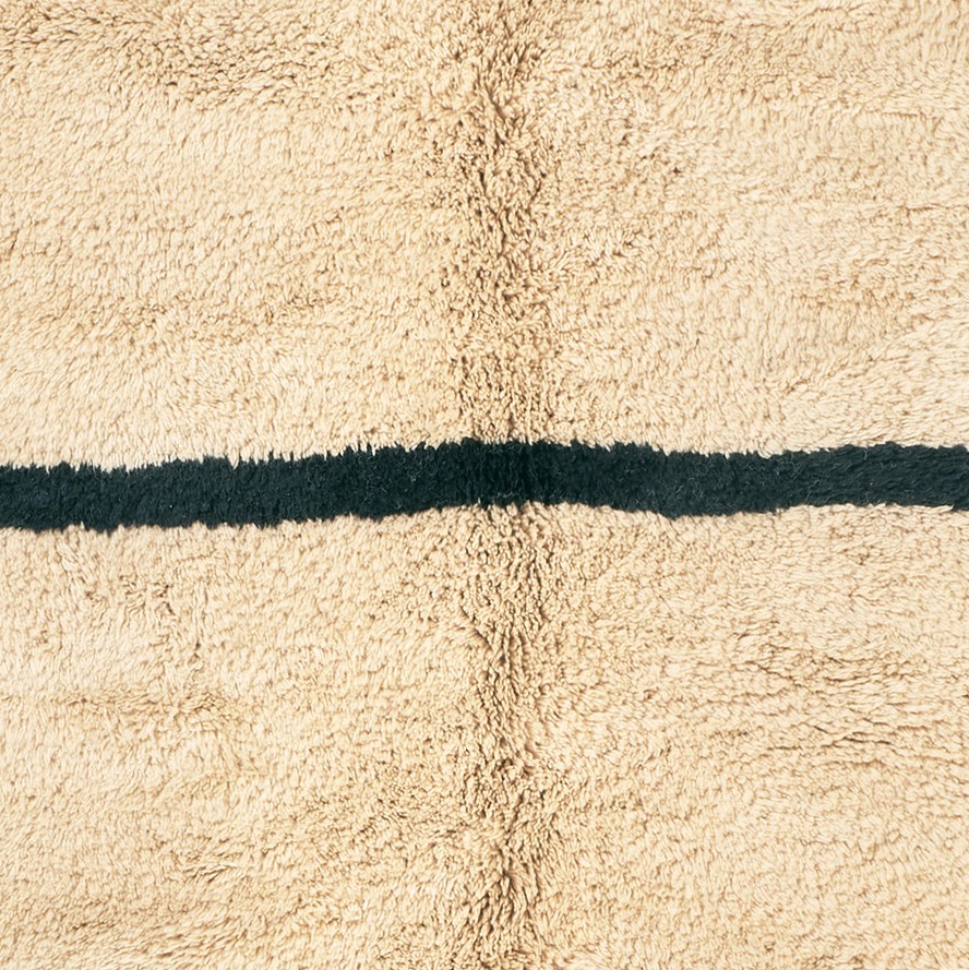 a rug with a black stripe on it