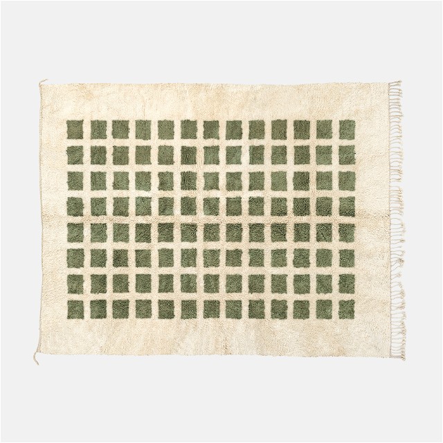 a green and white rug with squares on it