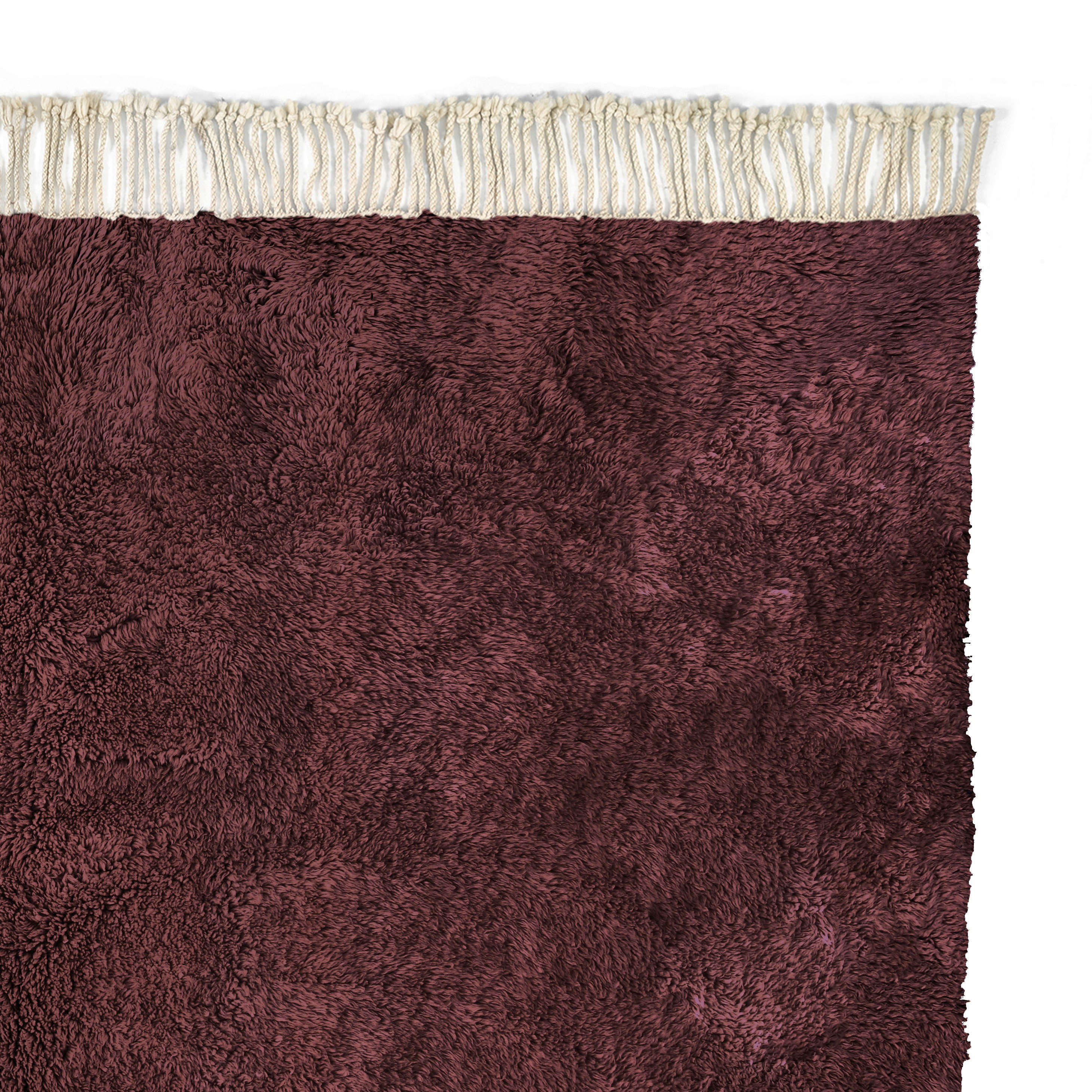 a purple rug with fringes on top of it
