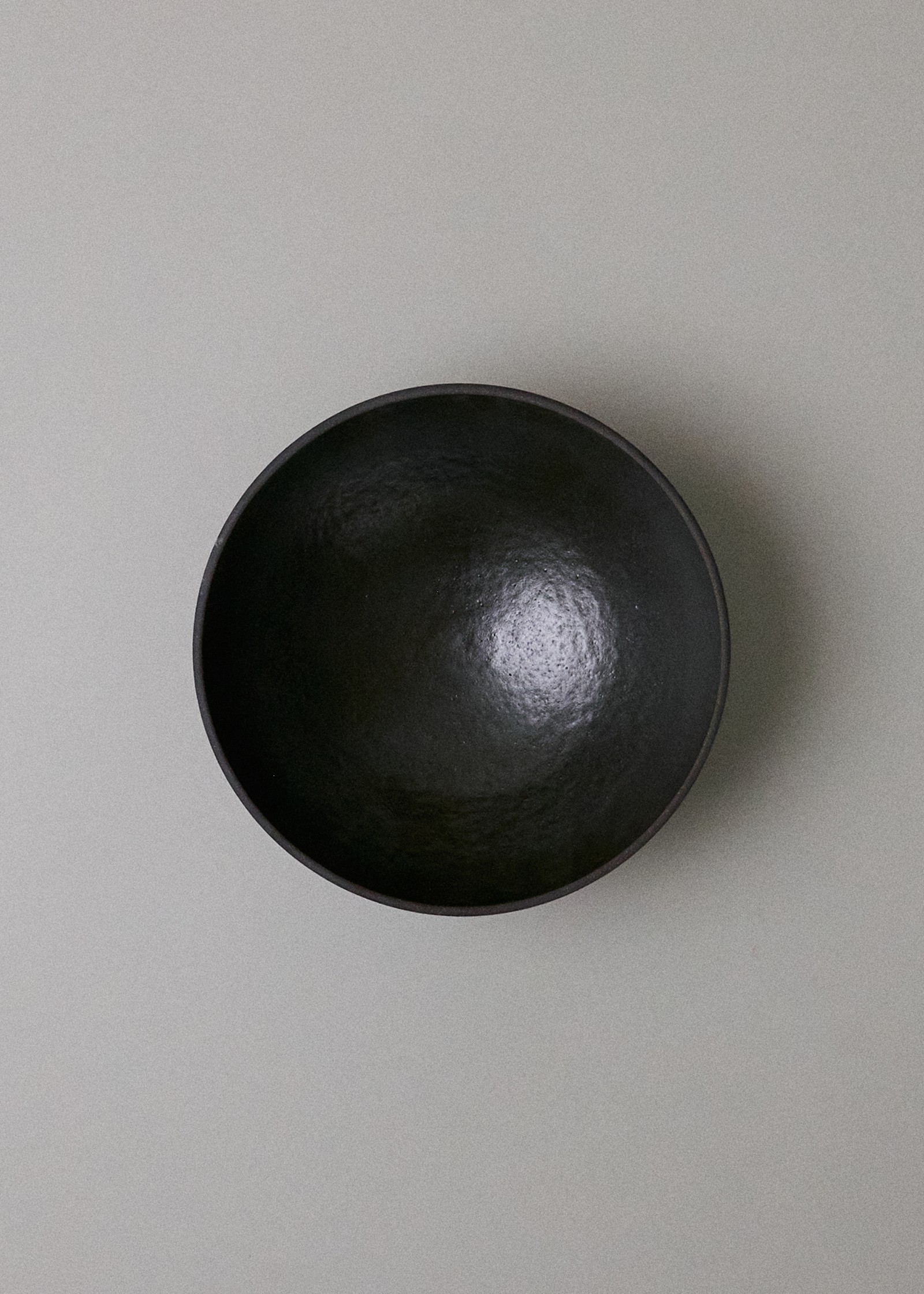 a black bowl sitting on top of a white table