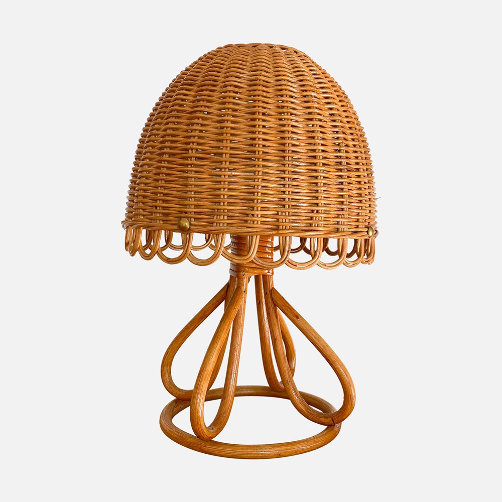 a wicker table lamp on a white background
