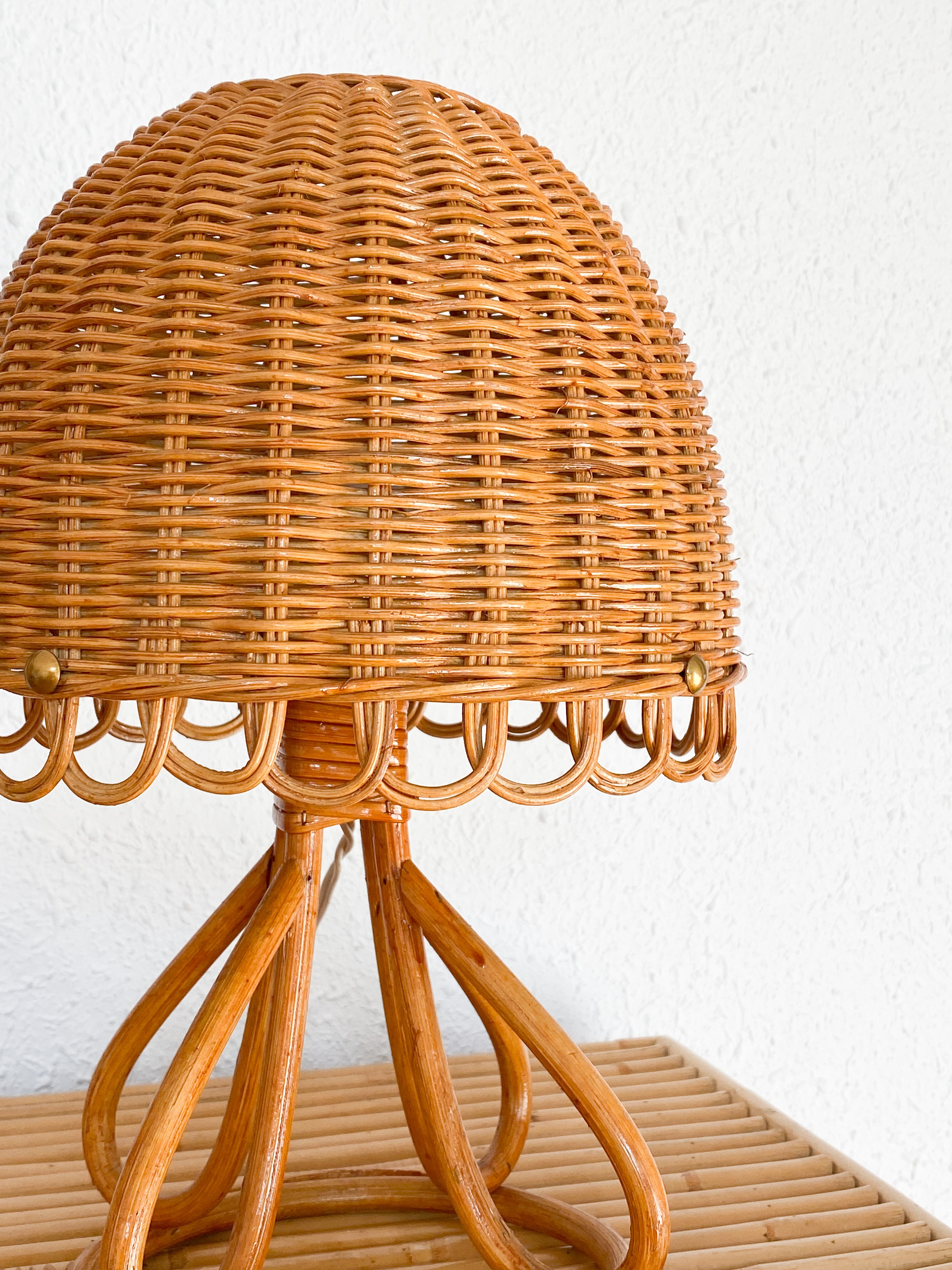 a wooden table with a wicker lamp on top of it