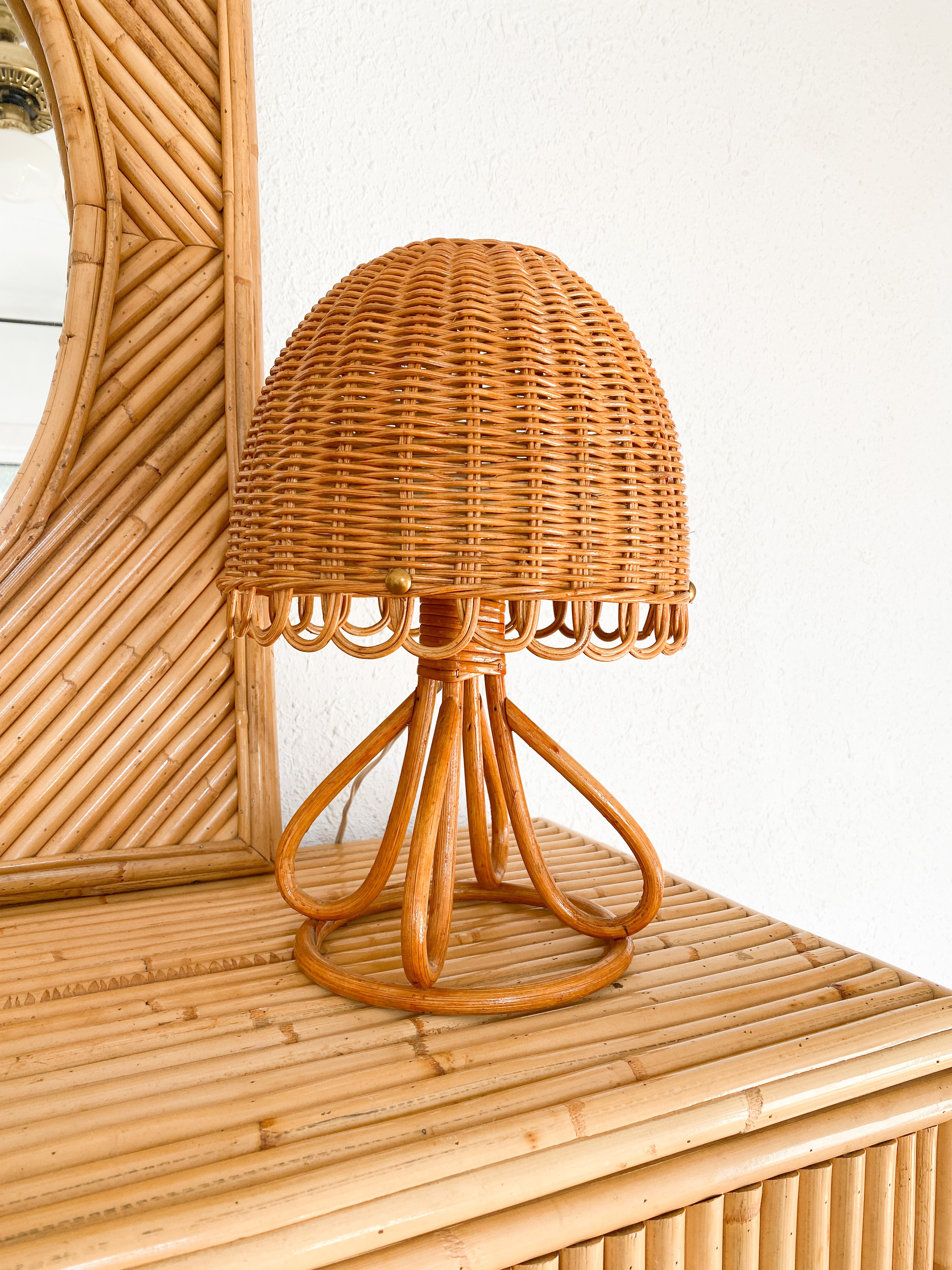 a wicker lamp sitting on top of a wooden table