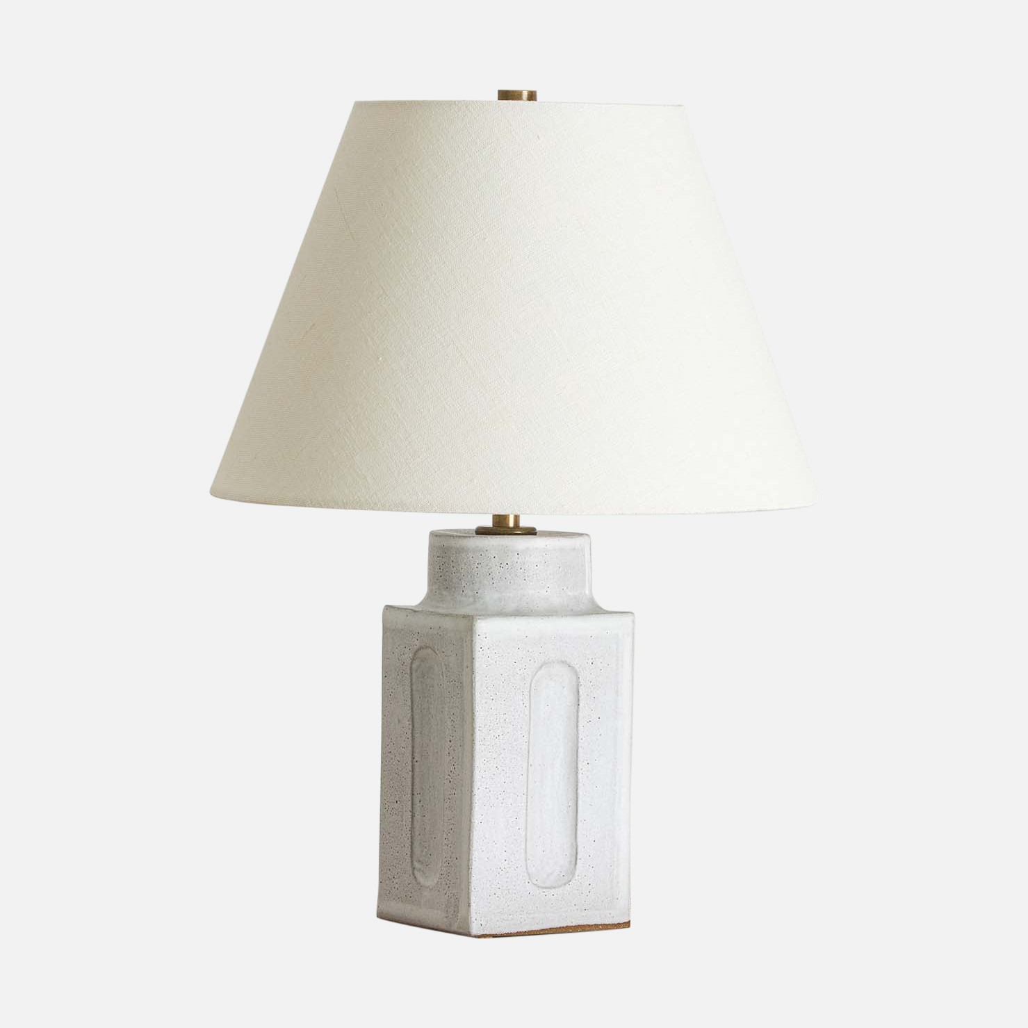 a white ceramic lamp with a white shade