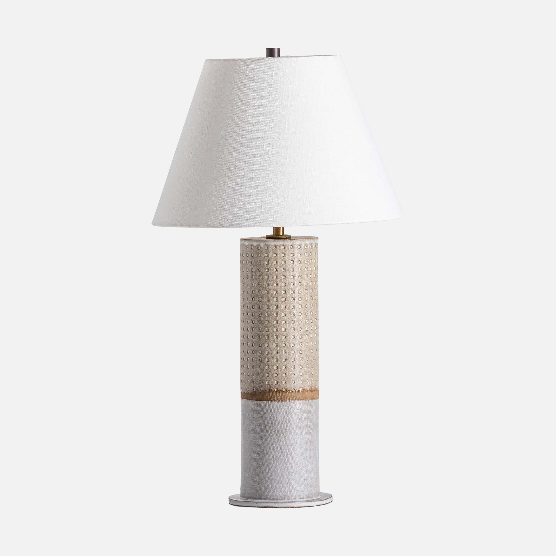 a table lamp with a white shade on top of it