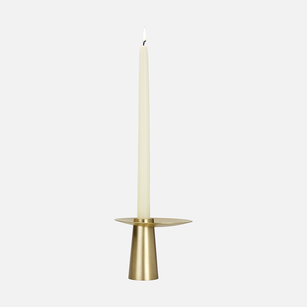 a gold candle holder with a white candle
