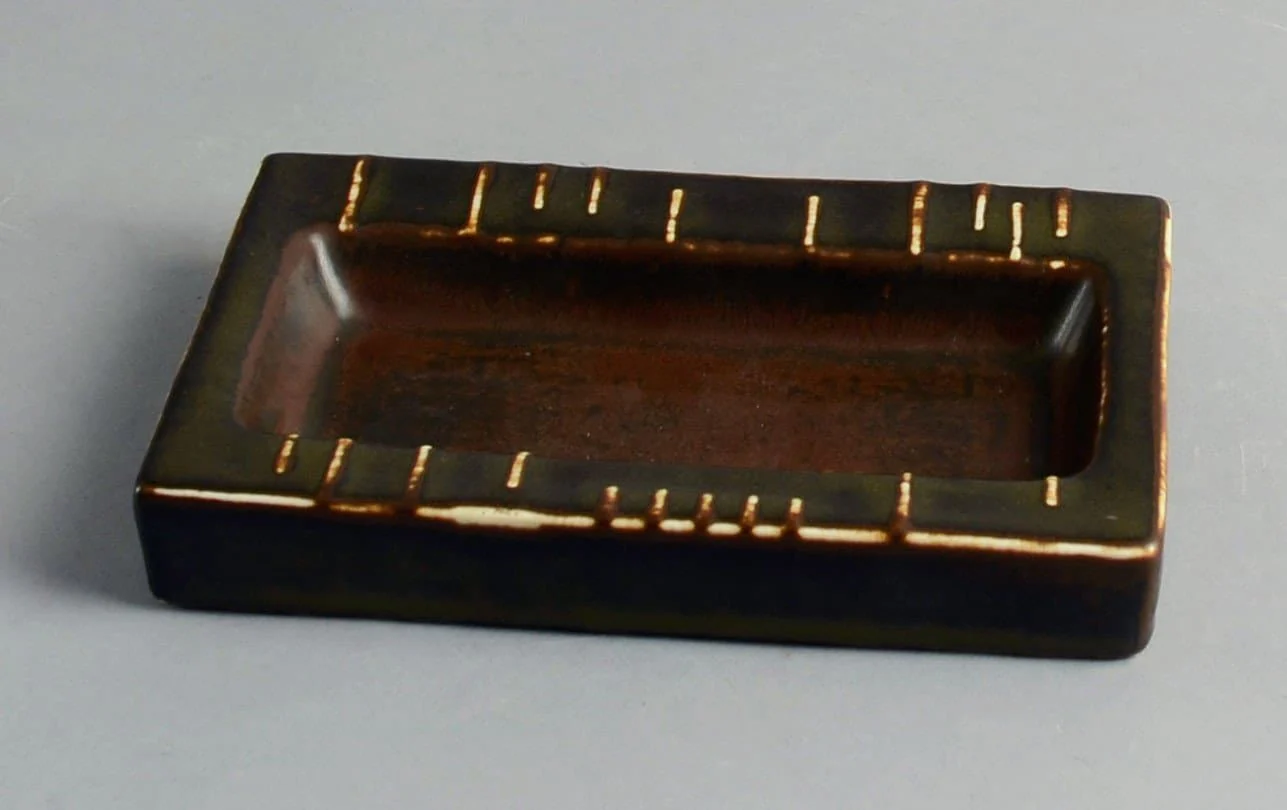 a small wooden tray with a handle on a table