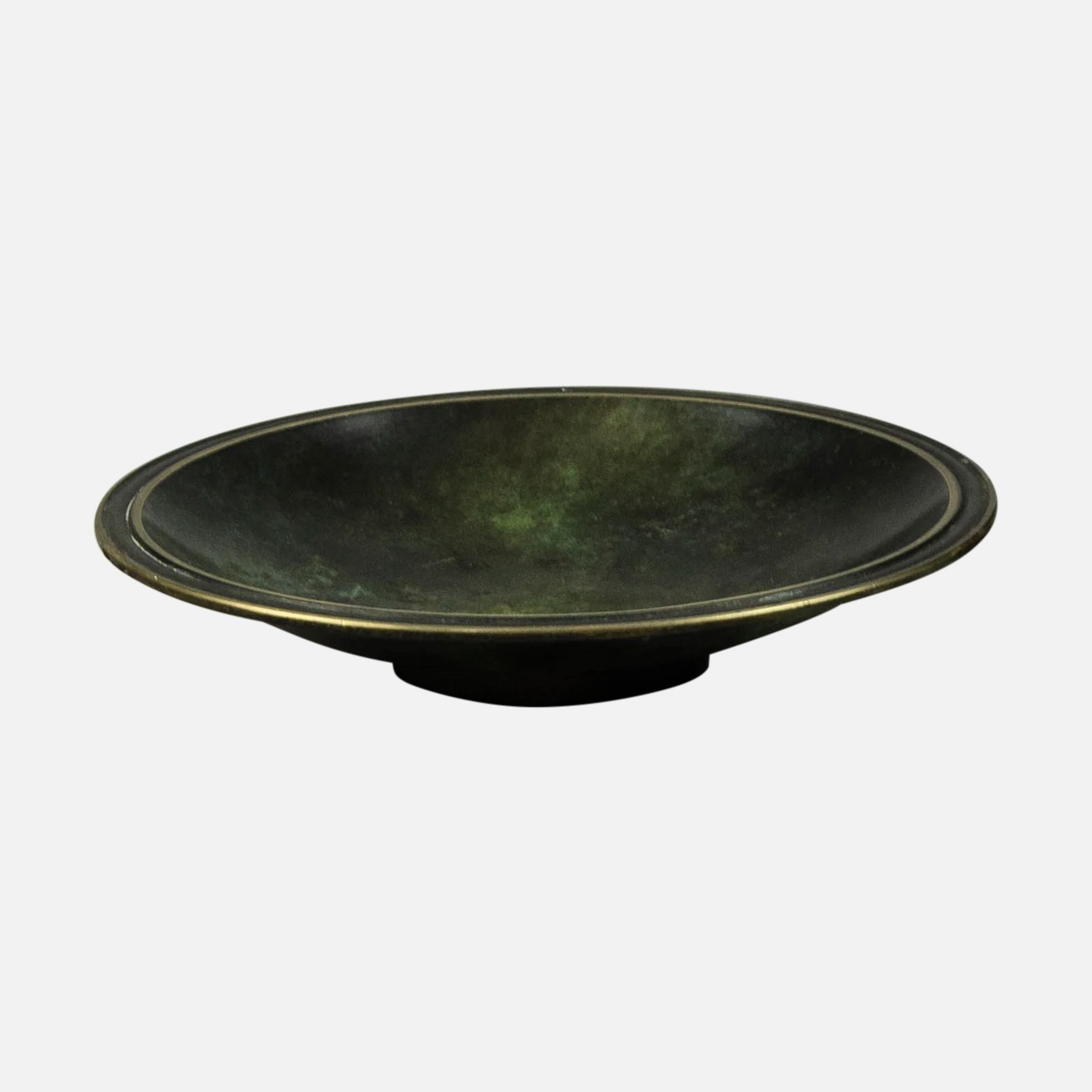 a black bowl with a gold rim on a white background