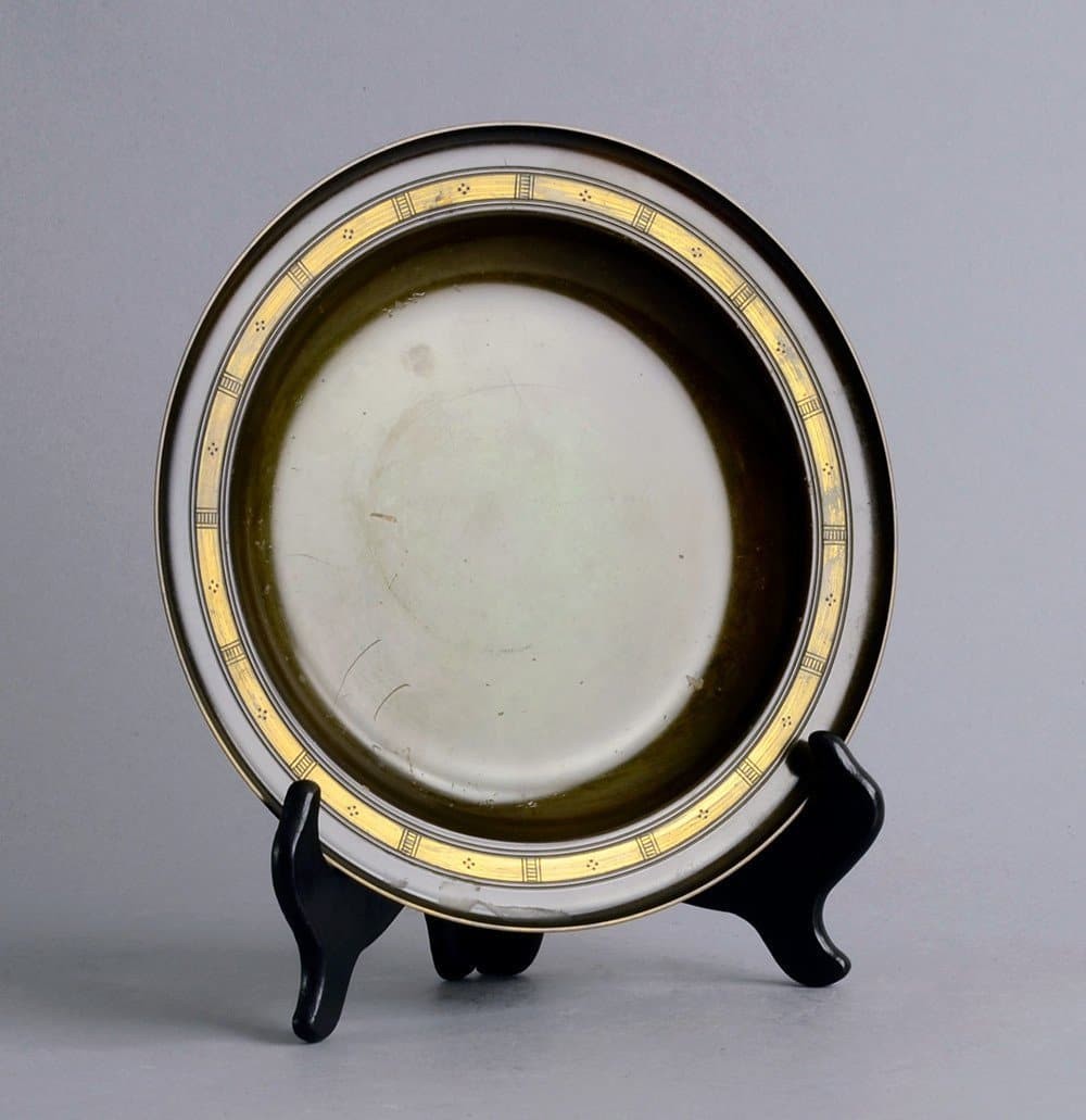 a black and white plate on a stand