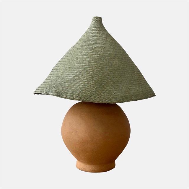 a brown vase with a green shade on top of it