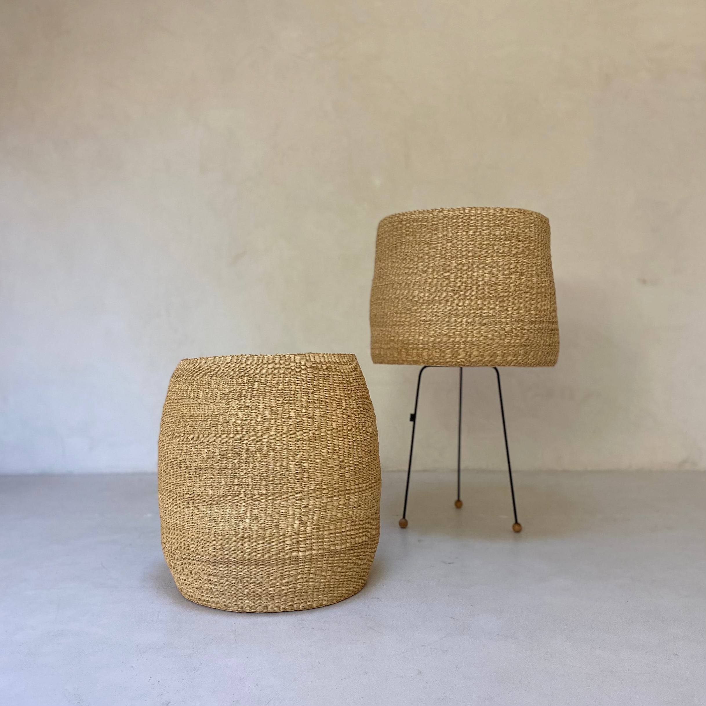 a pair of stools made out of straw